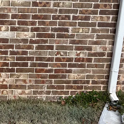 Red dirt stains removed from a brick wall